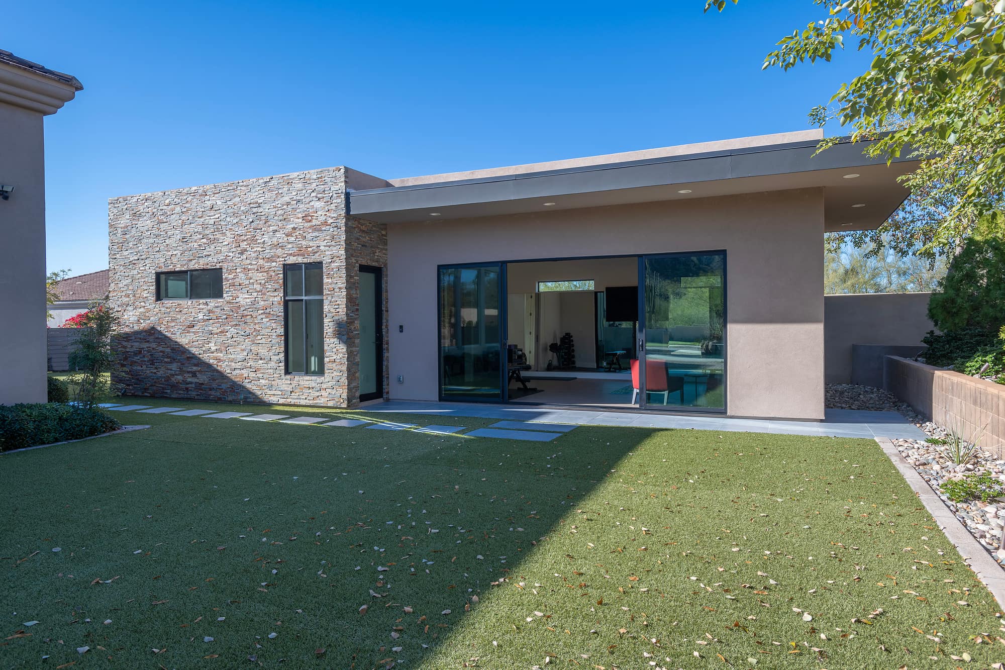 Finished casita with stacked stone, stucco, and sliding doors open to the interior